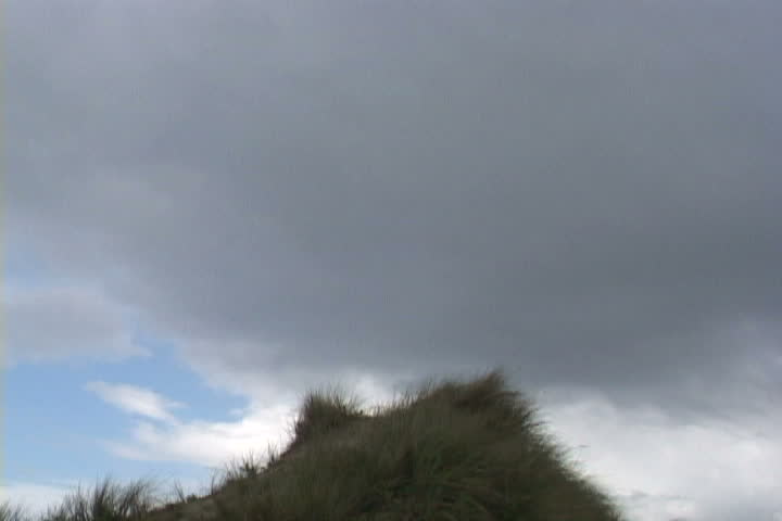Man runs and jumps off sand dune three times. OUCH!
