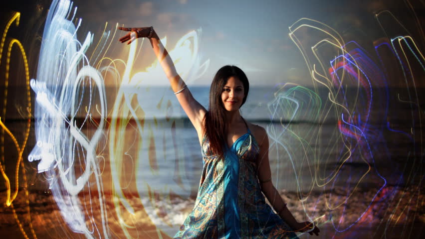 young woman dances on a beach at sunrise, shot with canon 5d mk2, barcelona, spain