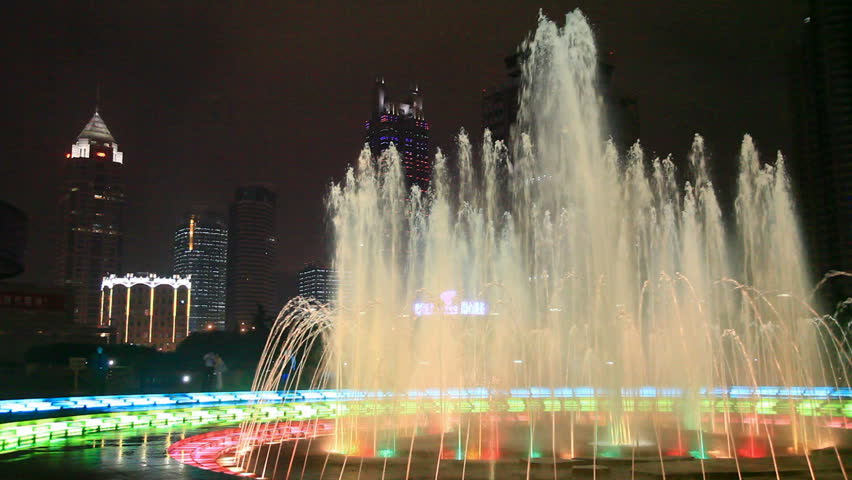 Fountain glows lights in night 