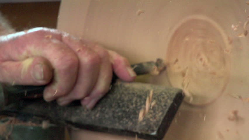 Dargaville, New Zealand. May 2013. Filmed slow motion close up of wood carver creating a timber bowl from swamp kauri