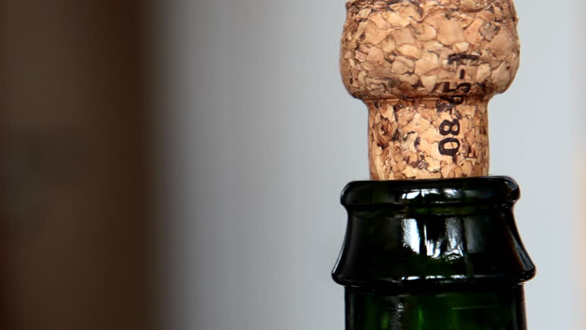 Cork flying off a bottle of sparkling french cider