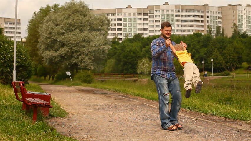 Father turns child's hands.