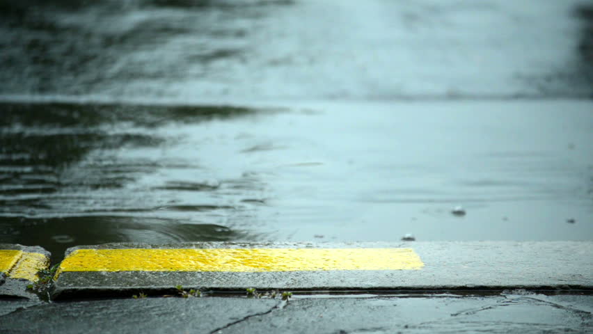 Rain drops falling on the road 