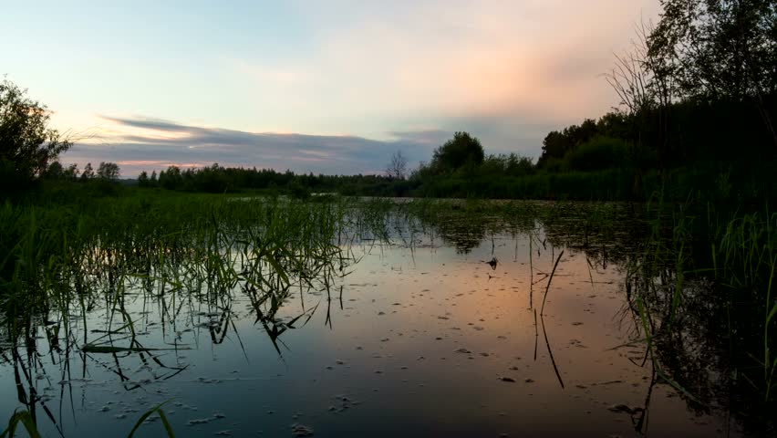 Sunset reflected in river. Night comes. River. 4K