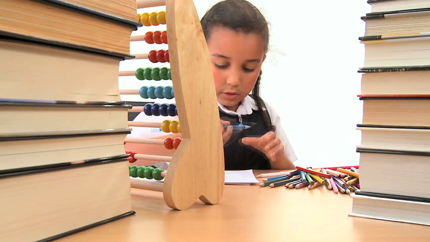Cute african american schoolgirl early learning with colored crayons