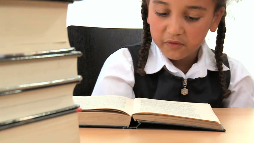 Cute african american schoolgirl early learning with reading books