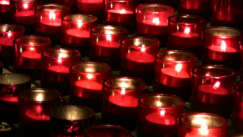 Video oblique rows offering prayer candles sanctuary Catholic Cathedral San Antonio Texas. Bright flames candle flickering in slight breeze. Steel and brass holders. Don Despain of Rekindle Photo.