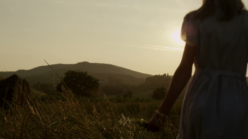 Mom with daughter walking in nature at sunset. Shot on RED Digital Cinema Camera in 4K, so you can easily crop, rotate and zoom, without losing quality!