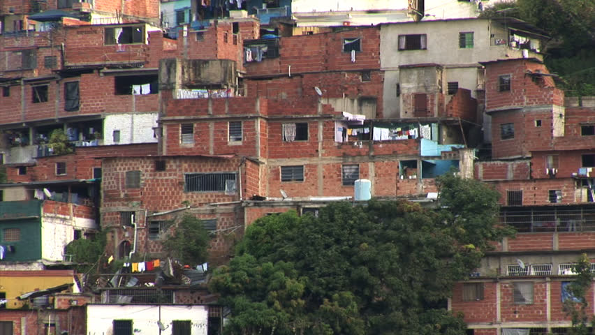 Slums in Caracas with rich condominiums looming overhead