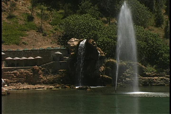 Rocky swimming cove with waterfall and fountain
