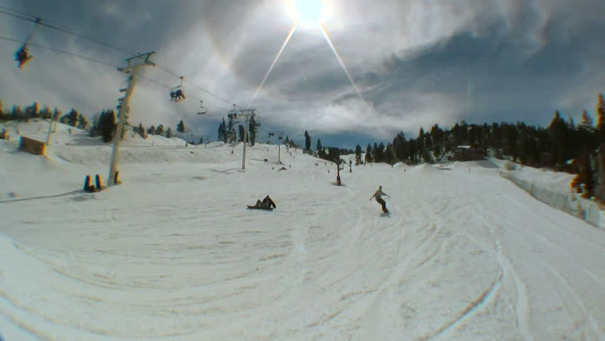 A snowboarder hits a jump and spins a 540 degree rotation.