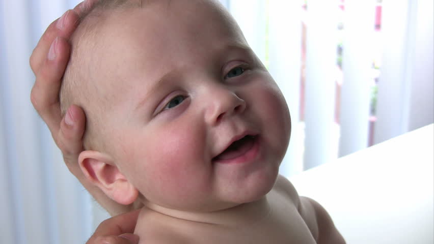 Closeup of a happy baby smiling and playing