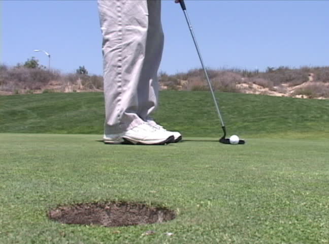ball putt into hole