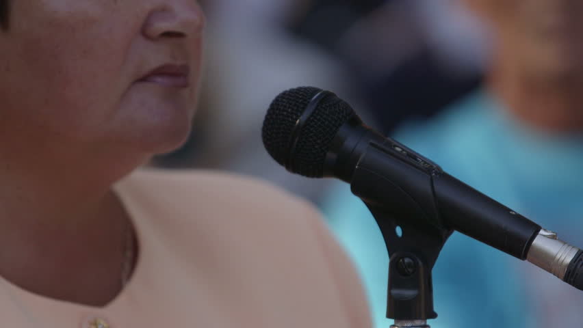 Female public speaker talking into the microphone