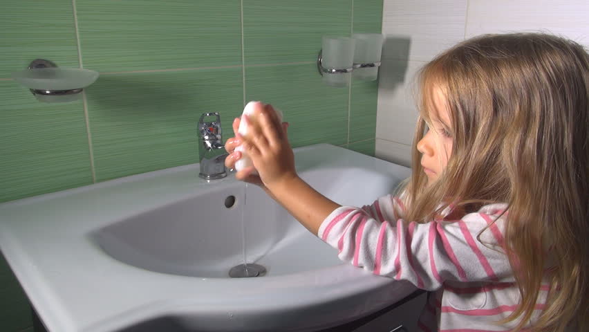 little girl on bathroom sink