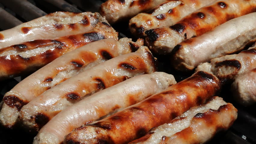 Sizzling sausages on a bbq grill