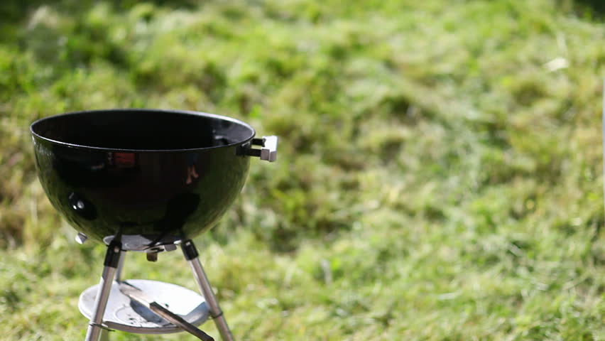Grilling at summer weekend. Man preparing the grill.