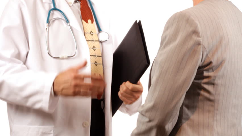 A doctor and a businesswoman or patient who appear to be finishing a discussion, shake hands.