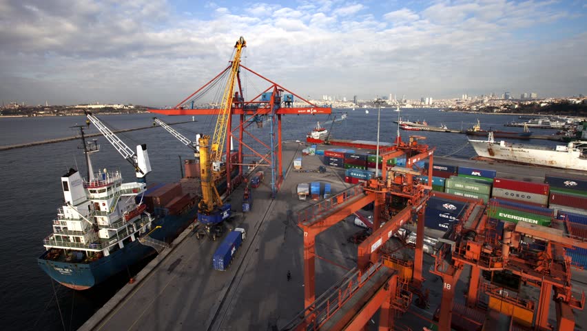 Cargo ship moving load at port (Time lapse)
