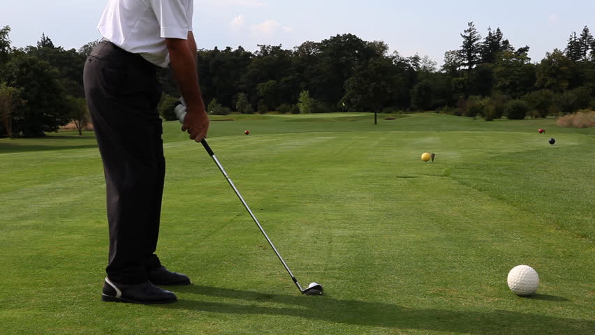 Golf player teeing off on beautiful golf course