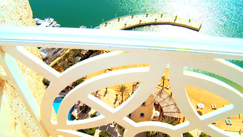 View of turquoise sea & golden beach from balcony of a luxury apartment