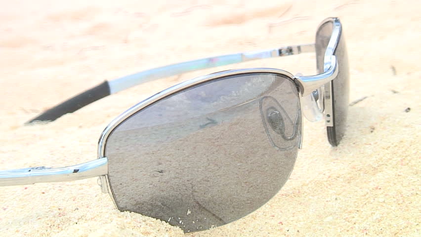 Reflection of the beach in the sunglasses in the sand. HD 1080