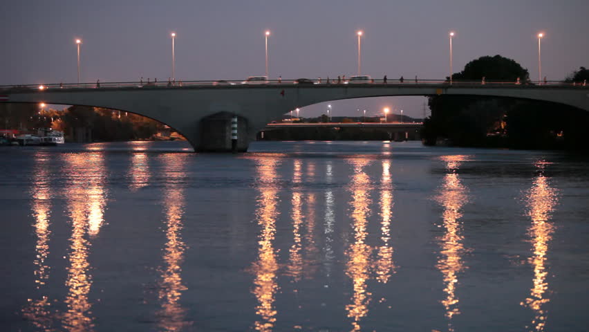 Bridge at dusk - Bridge over a large river with lots of movement on it - people, cars everybody seems to be in a rush