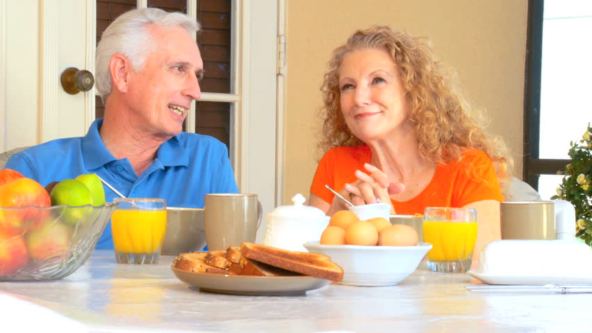 Contented retired couple enjoying a healthy outdoor breakfast  lifestyle