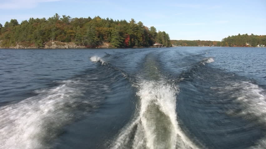 Motorboat wake. Two shots. Passenger POV from back of motor boat. Muskoka, Ontario, Canada. 