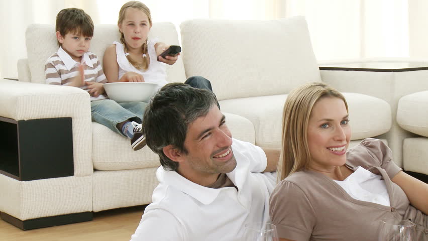 Footage in high definition of family watching television in living-room 