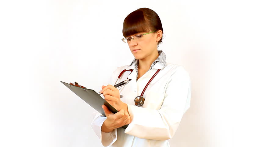 Female doctor in glasses recording something on notepad