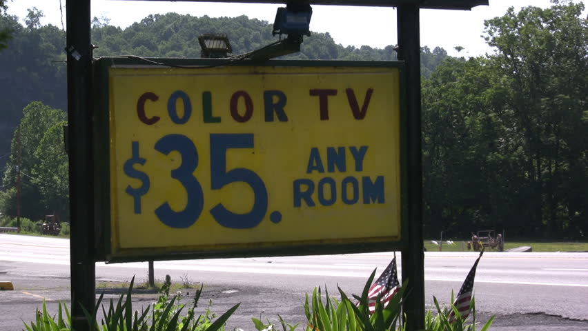 Color TV Motel sign next to road