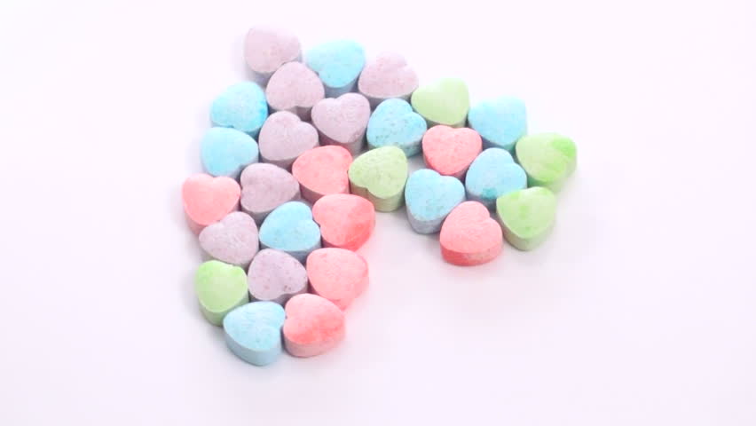 Zoom on heart shape made with sweetheart candy
