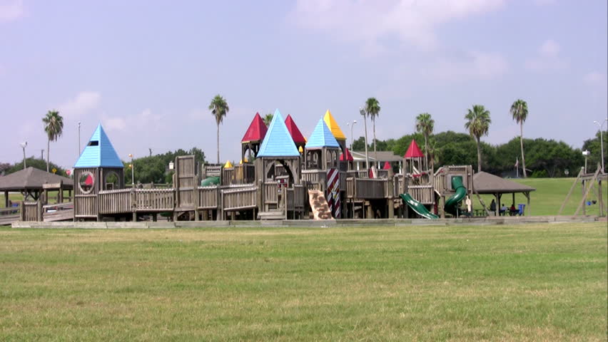Video of playground wood castle structure for a kids or children park. Oversize jungle jim with buildings, bridges and walks in a city park. Kids activity and recreation. 