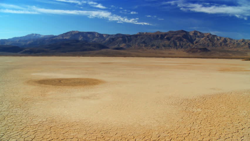 Petrified tree in barren environmental landscape with desert hills background