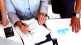 Business people examining graphs at workplace