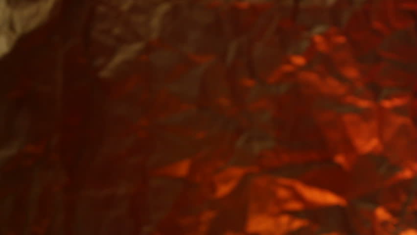 High wattage light bulb slowly turning on then off on a colored background. Panning Shot