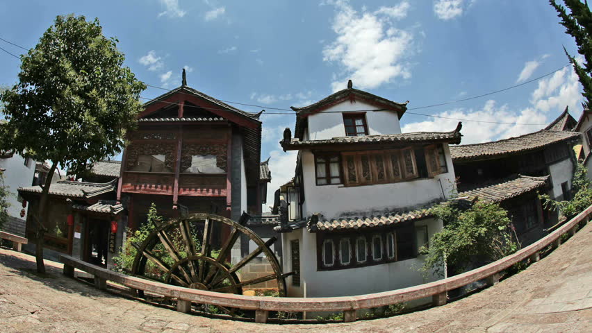 Lijiang, China, - March 20: A water wheel marks the entrance to Lijiang's "Old Town". Lijiang, Yunnan, China, Lijiang, China, - March 20, 2010