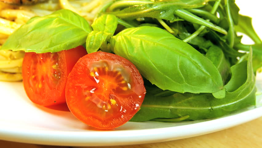 Healthy low calorie meal of pasta & fresh salmon displayed with fresh vegetables