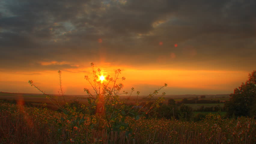 Warm sunset over fields, motorized time lapse clip, high dynamic range imaging (HDRI)