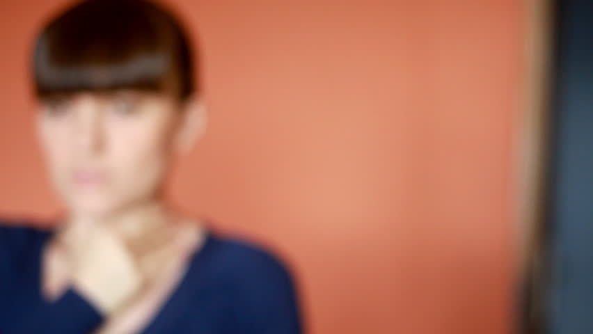 Dolly shot of a Young woman coughing 