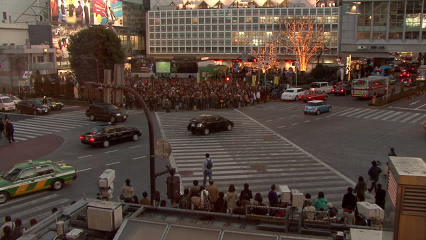 TOKYO - JANUARY. Pedestrians cross the famous Shibuya crossing in front of the JR railway station. January 14, 2010.
