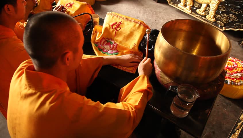 LESHAN, CHINA - AUGUST 24: Buddhist monks performing ceremony inside Baoguo monastery, Leshan, Sichuan, China, August 24, 2009