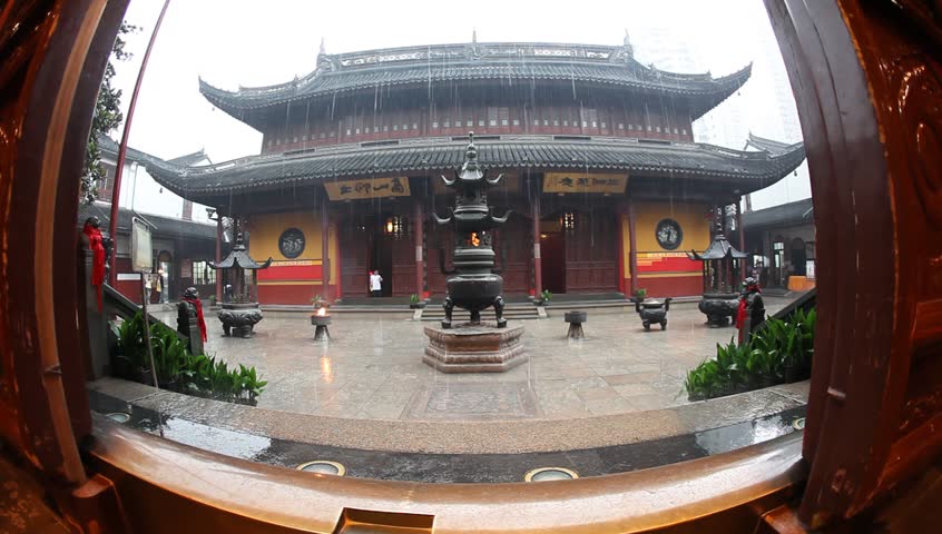 SHANGHAI, CHINA, - Buddhist visitors pray and light incense to practice their belief at Jade Buddha Temple (Yufo Si) - Shanghai, China, July 08, 2009