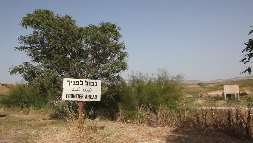 Frontier ahead sign in three languages on the border between Israel and Jordan