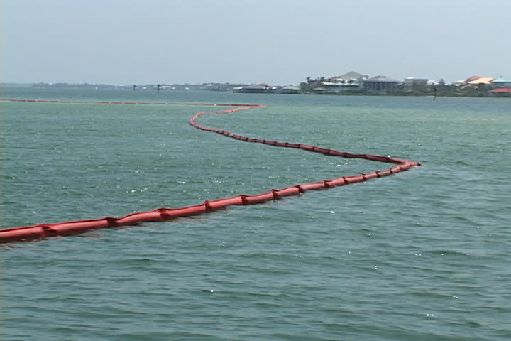Oil booms designed and anchored in the water to hold back floating spills, protect the shoreline in the inter coastal waterways of coastal southern Alabama from an oil disaster.