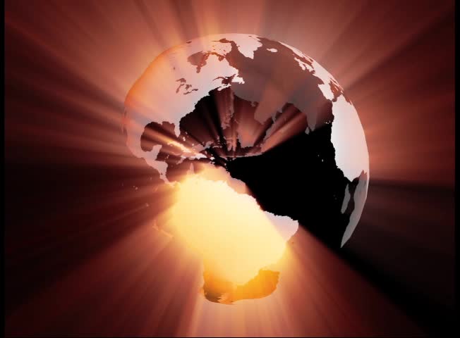 Globe Seamless Loop spins one time every thirty seconds. Gray land masses (no oceans) have a warm tone shimmering shining light.