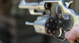 Loaded revolver chamber spinning in slow motion.