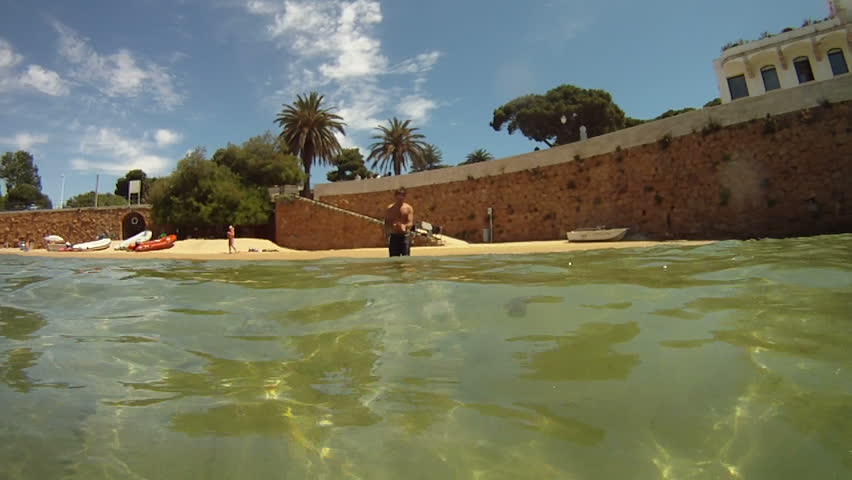 Man running and diving into sea
