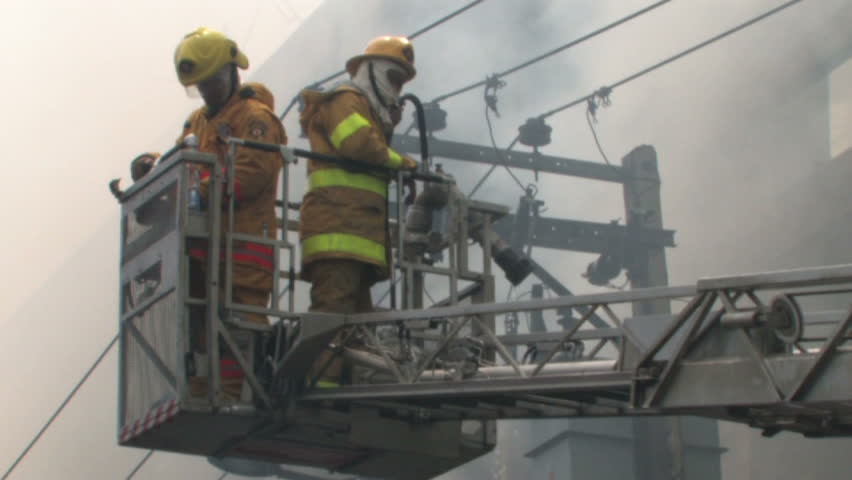 BANGKOK, THAILAND - April 19, 2010: Firemen battle blazes across the city after protesters set more than 40 buildings on fire during a government crackdown 